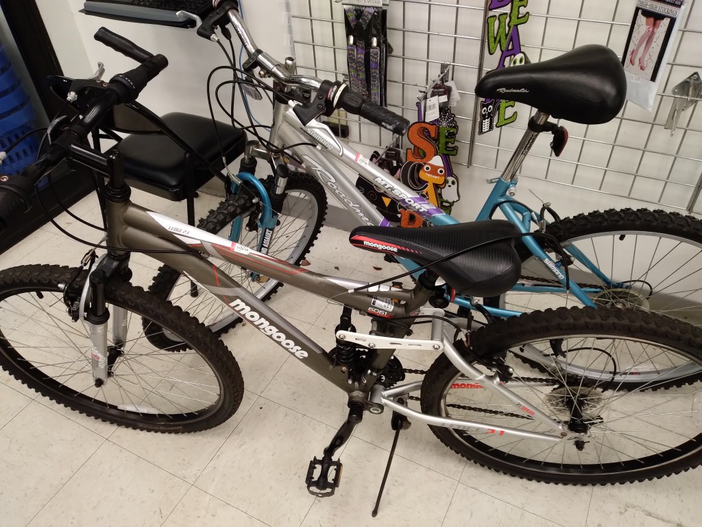 Broken bicycles displayed at thrift store