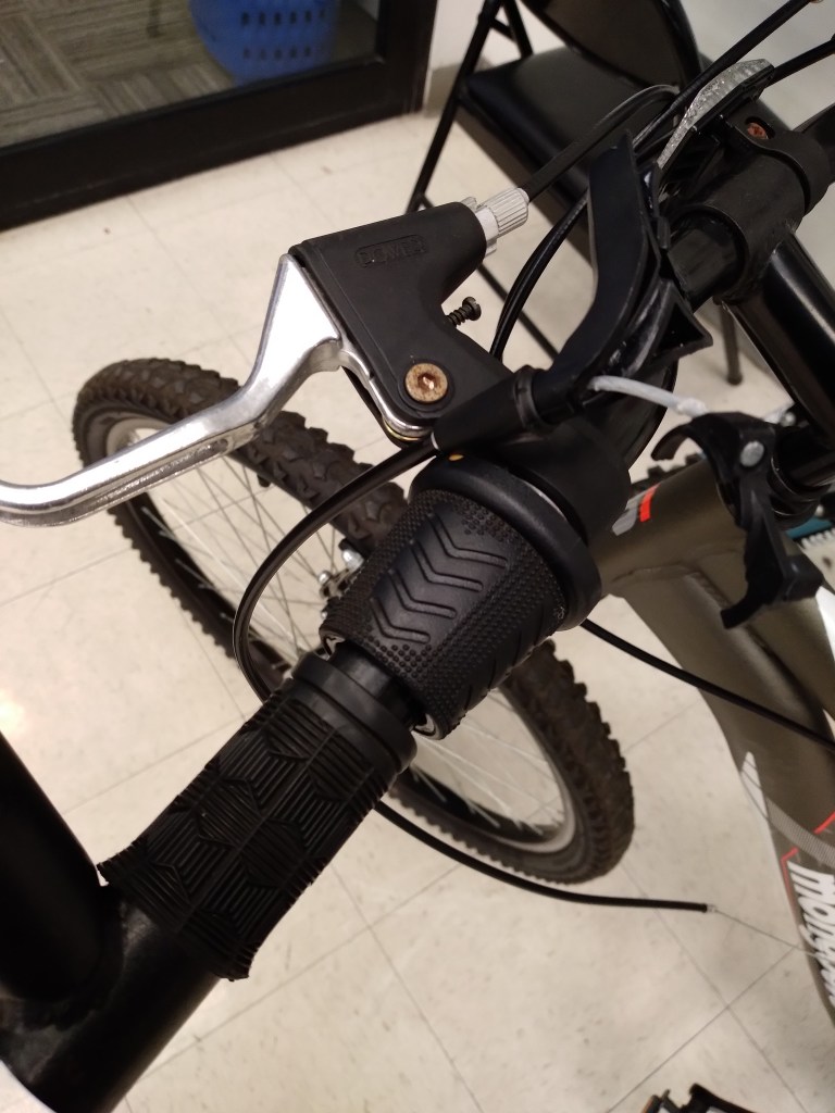 Broken left shifter on a mountain bike for sale at a thrift store.